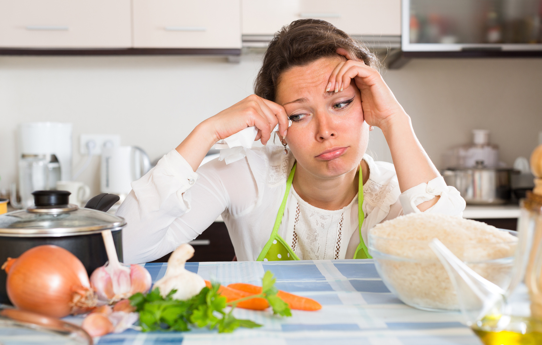 Sad housewife cooking dinner
